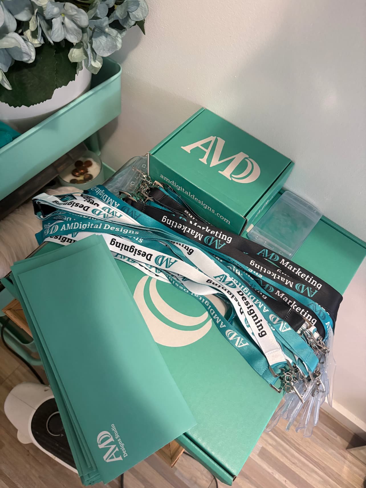 AM Digital Designs branded lanyards and hats